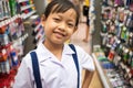 Asian uniform student girl in stationery store buying pens and school supplies.Back to school concept Royalty Free Stock Photo