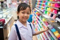 Asian uniform student girl in stationery store buying pens and school supplies.Back to school concept Royalty Free Stock Photo