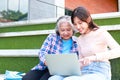 Asian university students of different ages use laptops to study and prepare for exams or work on group projects. Royalty Free Stock Photo