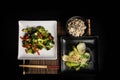Asian vegan vegetarian food menu on dark background top view. Pack choy stir fry vegetables and rice bawl dish on black table