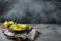 Asian vegetarian noodles with vegetables and lime in black rustic ceramic bowl, wooden chopsticks on cutting board angle Royalty Free Stock Photo