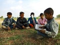 Asian village kids operating laptop at natural background in india January 2020 Royalty Free Stock Photo