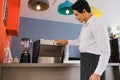 asia waiter served and serving coffee in cafe or restaurant