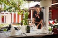 Asian waitress setting table in restaurant Royalty Free Stock Photo