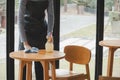 Asian waitress staff service woman in apron cleaning table with disinfectant spray for protect infection coronavirus covid-19 in Royalty Free Stock Photo