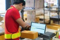 Asian warehouse man worker with computer and barcode scanner in warehouse scan at box prepare deliverly to customer