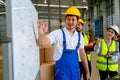 Asian warehouse worker use white board to explain about their team project workflow and look like they feel happy to work together