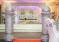 Asian wedding hall stage with silver armchairs and sofa