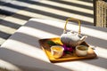 Asian white clay teapot with glazed clay bowls cups for green tea on wooden tray in spa with sun shades Royalty Free Stock Photo