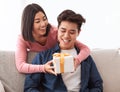 Asian Wife Giving Gift To Husband On Valentine's At Home