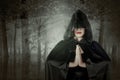 Asian witch woman with a cloak standing