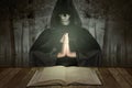 Asian witch woman with a cloak standing with a book on the table