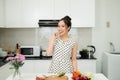 Asian wman preparing healthy meal in her rustic eco kitchen Royalty Free Stock Photo