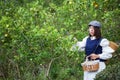 Asian woman work and travel in lemon farm with farmer fashion and accessories