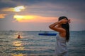 An Asian women admiring the sunset on Ba Keo Beach, Phu Quoc, Vietnam