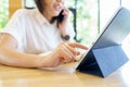 Asian woman aged 30-35 years, using digital tablet technology device enjoying internet study work shopping online using social