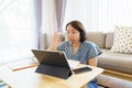 Asian woman aged 30-35 years using tablet, watching lesson online course communicate by conference video call from home, e- Royalty Free Stock Photo