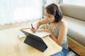 Asian woman aged 30-35 years using tablet, watching lesson online course communicate by conference video call from home, e- Royalty Free Stock Photo