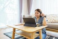 Asian woman aged 30-35 years using tablet, watching lesson online course communicate by conference video call from home, e- Royalty Free Stock Photo