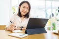 Asian woman aged 30-35 years using tablet, watching lesson online course communicate by conference video call from home, e- Royalty Free Stock Photo