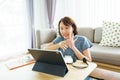 Asian woman aged 30-35 years using tablet, watching lesson Sign language online course communicate by conference video call from Royalty Free Stock Photo