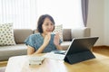 Asian woman aged 30-35 years using tablet, watching lesson Sign language online course communicate by conference video call from Royalty Free Stock Photo