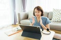 Asian woman aged 30-35 years using tablet, watching lesson Sign language online course communicate by conference video call from