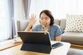 Asian woman aged 30-35 years using tablet, watching lesson Sign language online course communicate by conference video call from