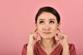 Asian woman annoyed and worried closing ears with fingers, Stressed and frustrated female ignoring solving problems. Royalty Free Stock Photo