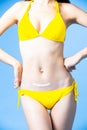 Woman apply sunscreen on abdomen