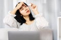 Asian woman applying eye drops to refresh dry, tired eyes from overworked on laptop screen