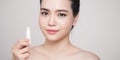Asian woman applying hygienic lip balm over grey background Royalty Free Stock Photo