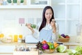 Asian woman in an apron cooking healthy food