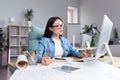 Asian woman architect designer working at desktop computer, drawing with pencil,working on project Royalty Free Stock Photo