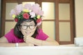 Asian woman with artificial flower bouguet decorated on head too