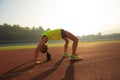 Asian woman backbending on stadium track