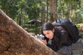 Asian woman backpack taking a photo with mirrorless camera Royalty Free Stock Photo