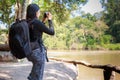 Asian woman backpack taking a photo with mirrorless camera Royalty Free Stock Photo