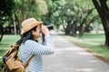 Asian woman backpack traveler take a photo when traveling at rain forest.Holiday vacation concept.journey lifestyle.solo travel. Royalty Free Stock Photo