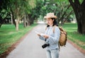 Asian woman backpack traveler use map when traveling at rain forest.Holiday vacation concept.journey lifestyle.solo travel