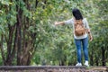 Asian woman backpacker standing on countryside road with tree in Royalty Free Stock Photo