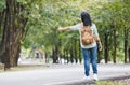 Asian woman backpacker standing on countryside road with tree in Royalty Free Stock Photo
