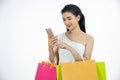 Asian women and Beautiful girl is holding shopping bags and using a smart phone and smiling while doing shopping online with Royalty Free Stock Photo
