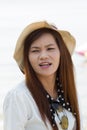 Asian woman in beautiful hat on tropical beach Royalty Free Stock Photo