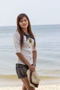 Asian woman in beautiful hat on tropical beach Royalty Free Stock Photo