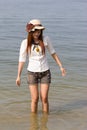 Asian woman in beautiful hat on tropical beach Royalty Free Stock Photo