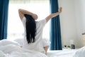 Asian woman Beautiful young stretching in the morning at bedroom after waking up in her bed fully rested Royalty Free Stock Photo