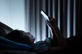 Asian woman on bed late at night and using mobile Royalty Free Stock Photo