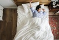 Asian woman on the bed waking up in the morning Royalty Free Stock Photo