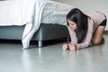 Asian female bent and searching something under bed lost thing in bedroom Royalty Free Stock Photo